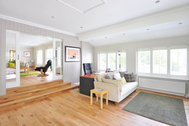 Open-concept-home-with-light-wood-flooring-and-white-walls