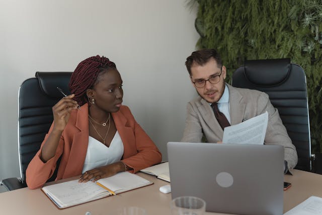 two people in a conference room during a meeting
