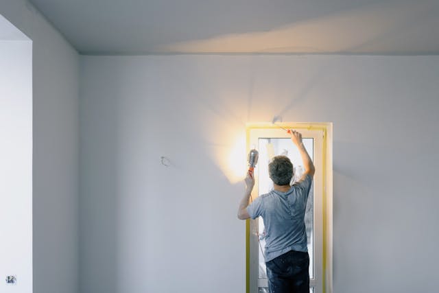 Person replacing a window