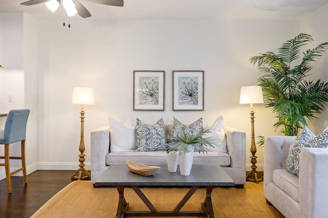 a living room with a two-seater linen couch and matching armchair