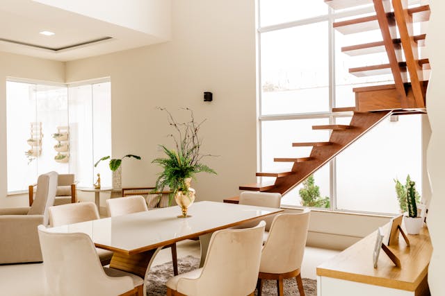 white and wood living room with big windows and plants
