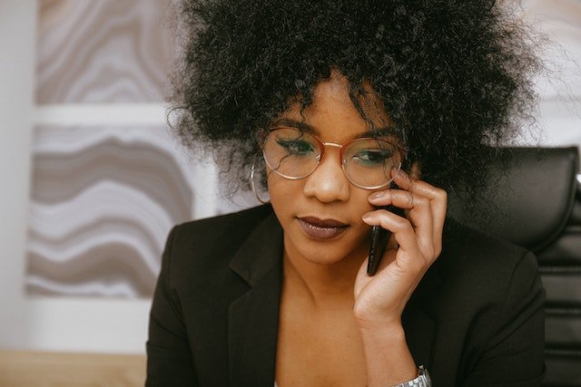 person in black blazer on the phone calling prospective tenant’s referrals